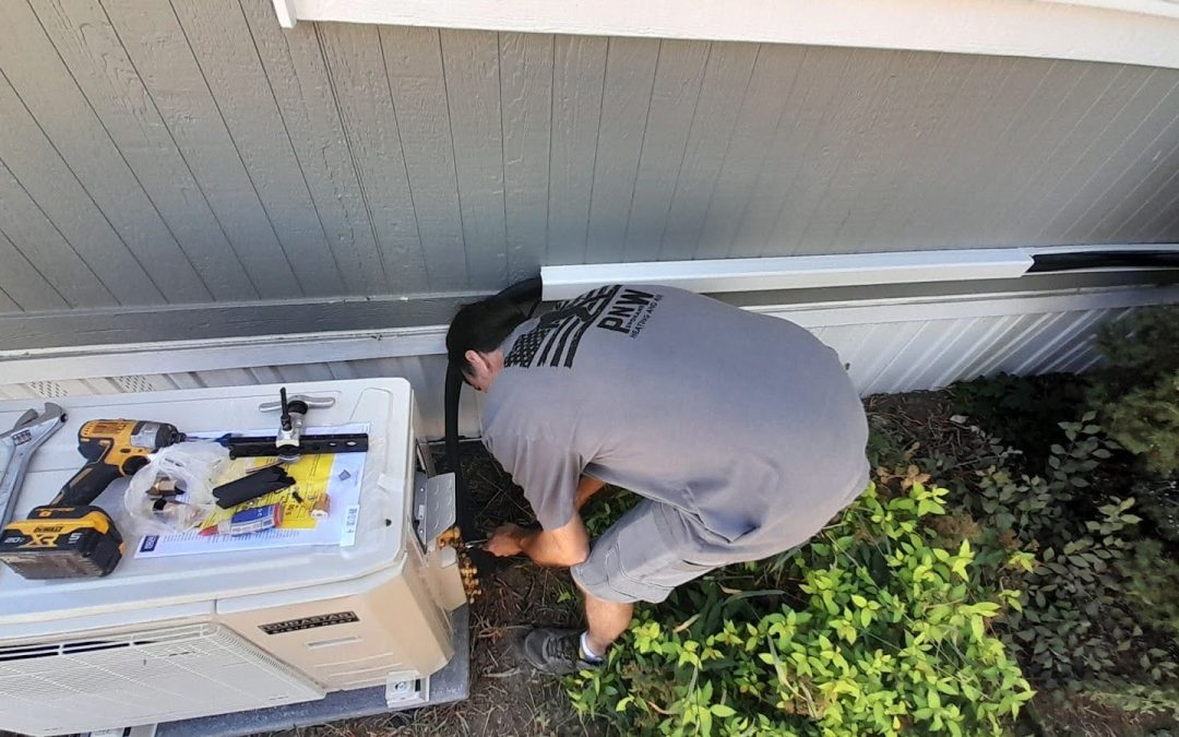 Technician performing maintenance on an outdoor HVAC unit, surrounded by tools and equipment, emphasizing PNW Heating and Air's service commitment in Spokane, WA.